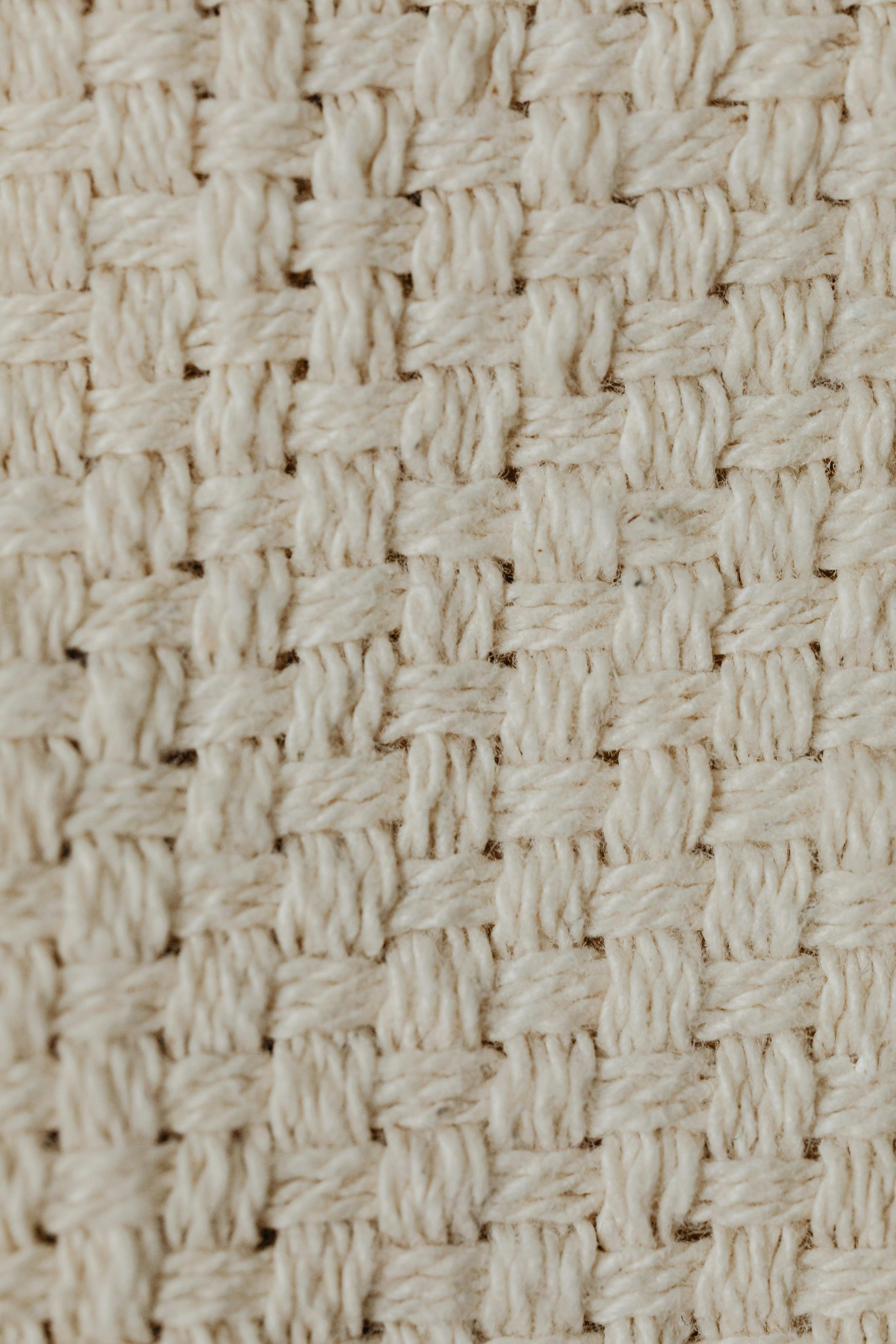 Macro de uma trama de tecido ou rede feita de fibras naturais, com padrão de nós entrelaçados.