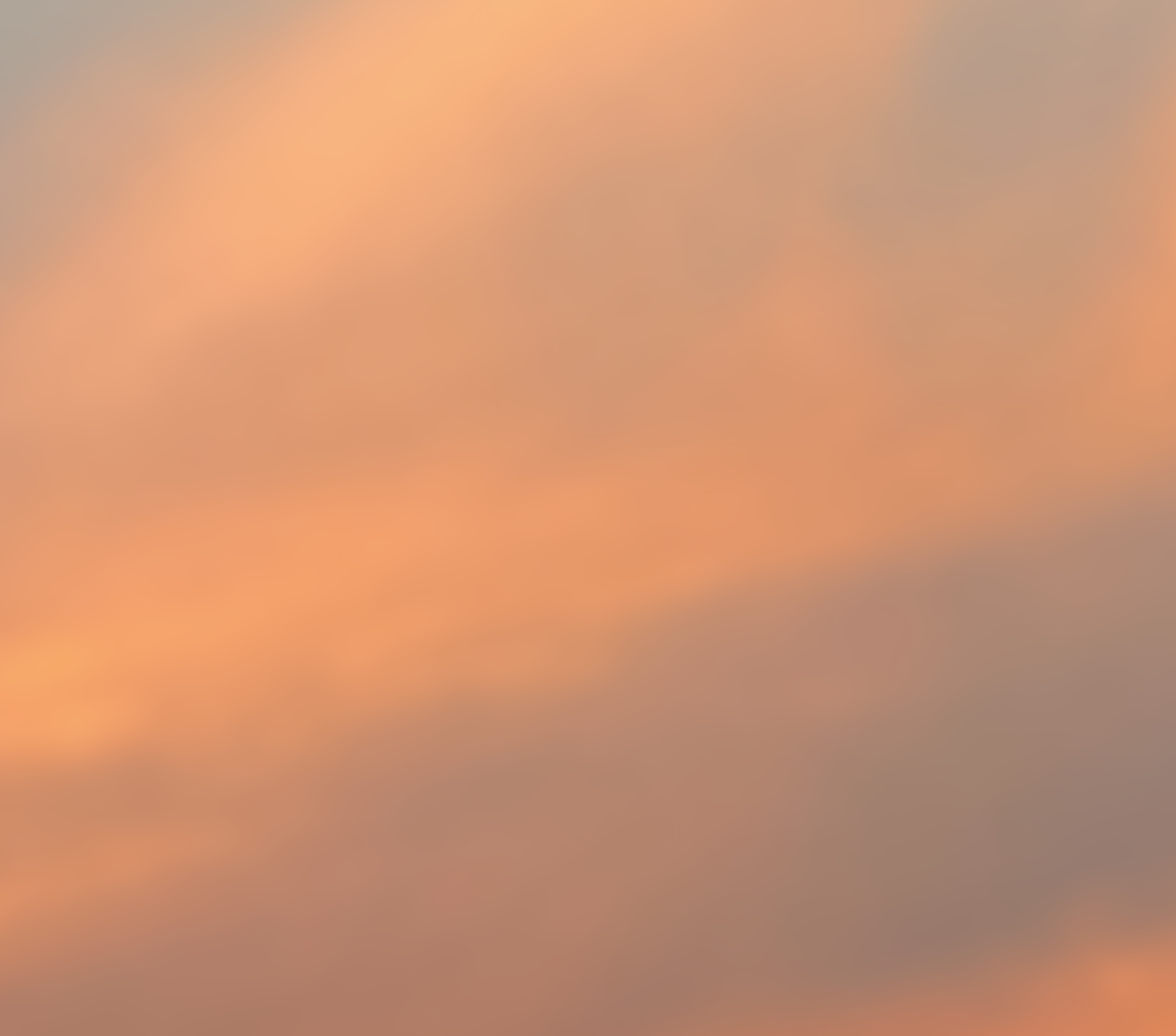 Blurred background with warm orange and pink tones, no distinct objects visible.