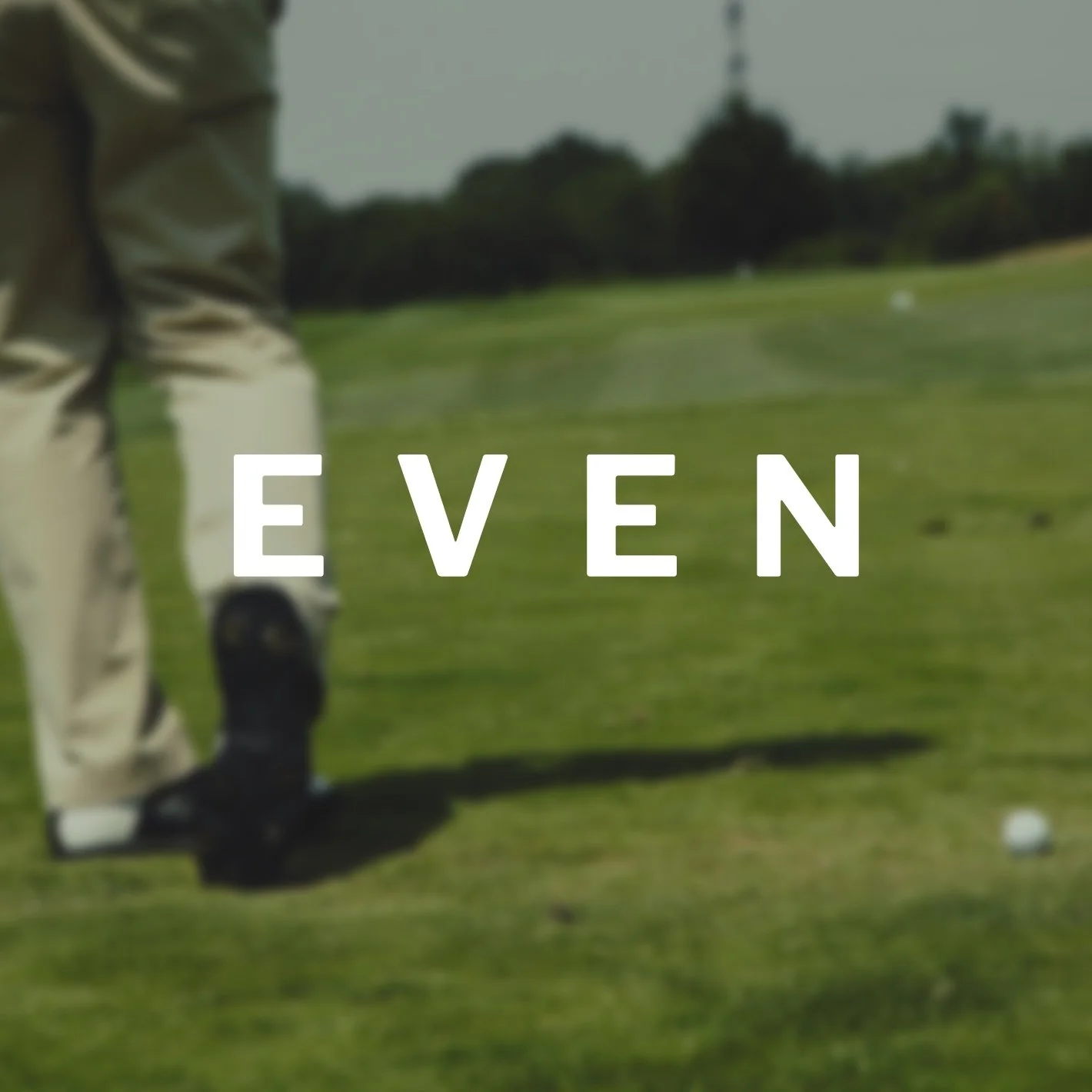 A person on a golf course preparing to hit a golf ball with a club, with the word "EVEN" overlaid on the image.