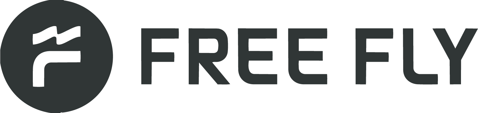 Logo of Free Fly, featuring a stylized propeller within a circle and the text "FREE FLY" to the right.