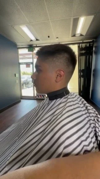 Mid taper fade with textured top, cut by barber Itzy J. at San Fernando Beard & Hair Studio on Rinaldi St, San Fernando CA