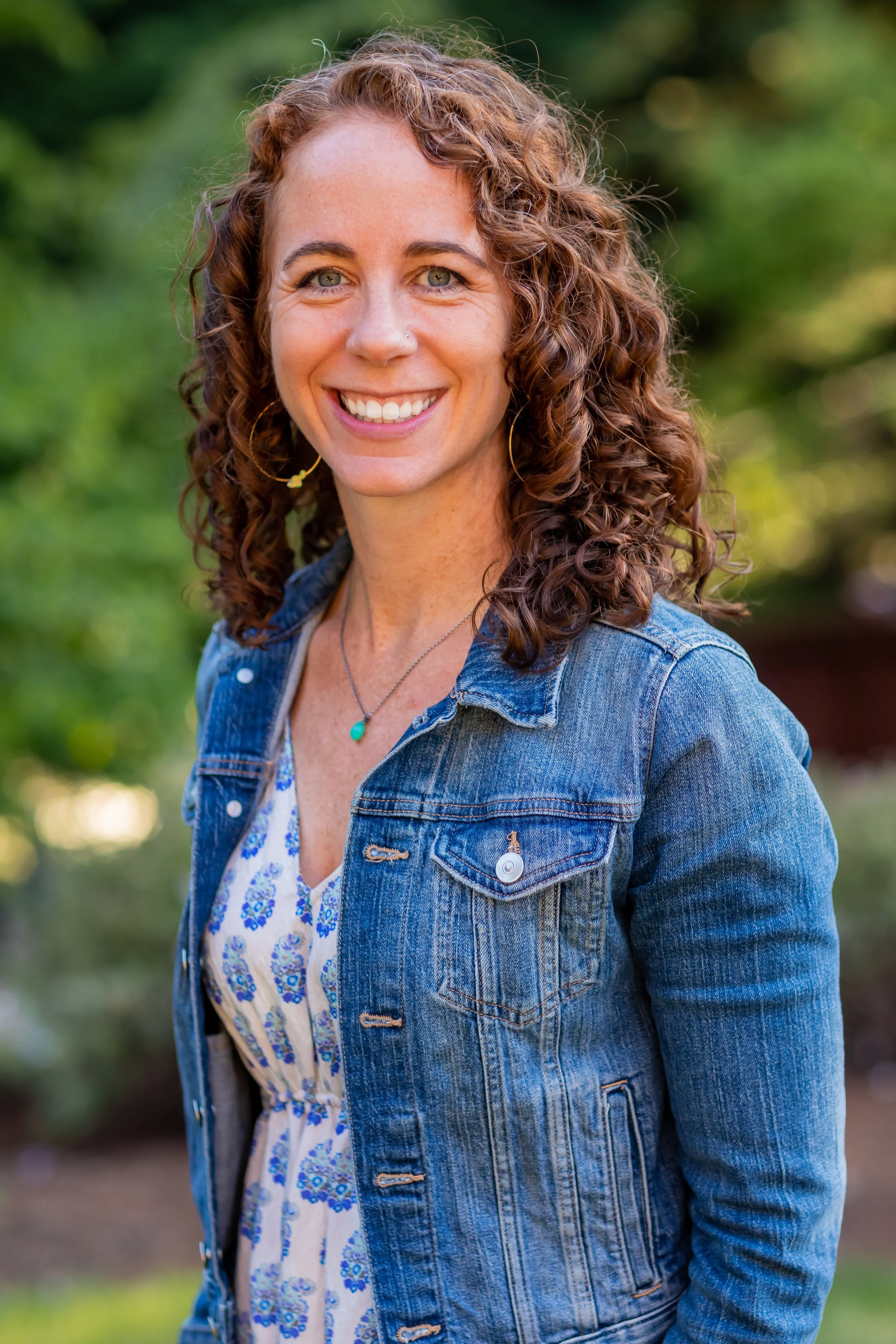 Portrait of Erinn Zavaglia, therapist and founder of A Place by the Fire, smiling outdoors in a natural setting