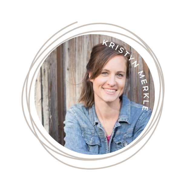 A young woman with shoulder-length brown hair smiling, wearing a denim jacket, standing outdoors in front of a wooden fence.
