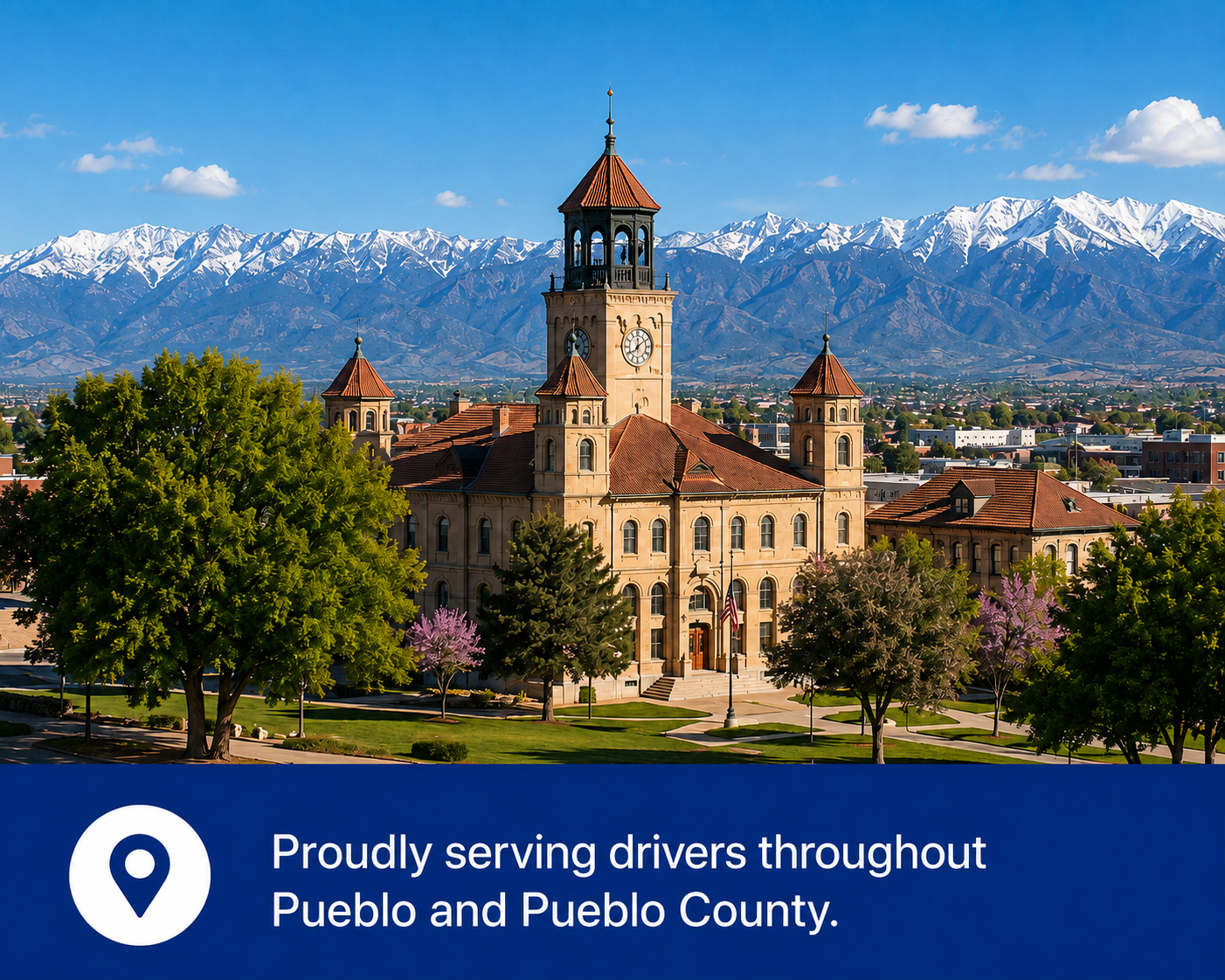 Photo of a historic building with a clock tower, surrounded by trees, with snow-capped mountains in the background, and a banner at the bottom reading 'Proudly serving drivers throughout Pueblo and Pueblo County.'