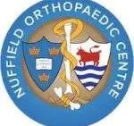 Buffer Orthopaedic Center emblem featuring a shield with a whale, a foot, and a cross, along with a golden staff and snake symbol.