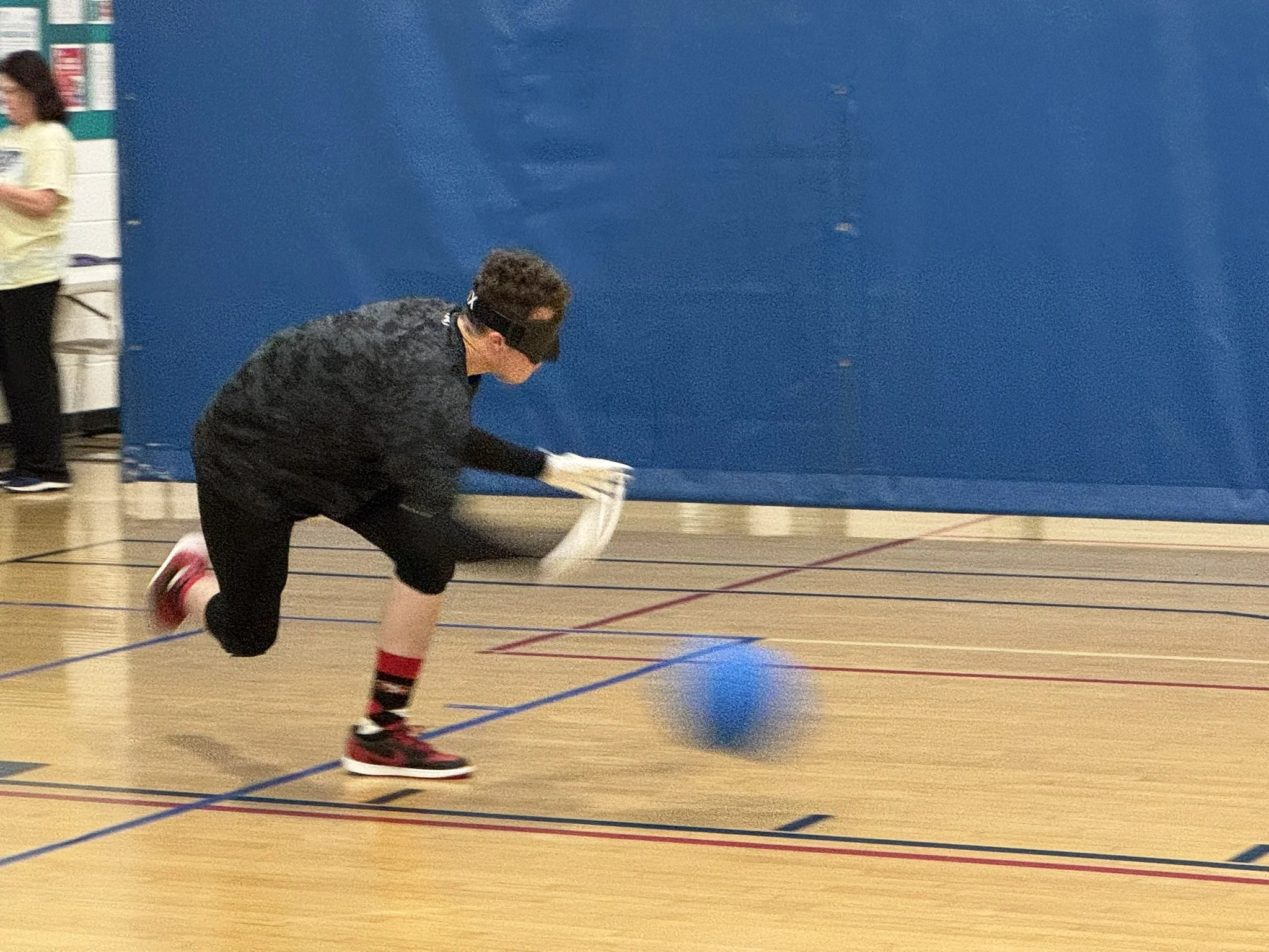 Jayden forcefully throwing a goalball at practice