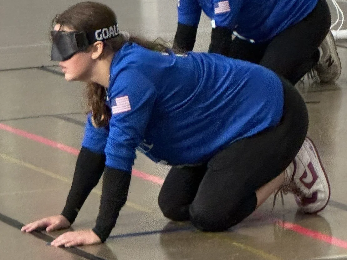 On the court defending the ball from going into the goal