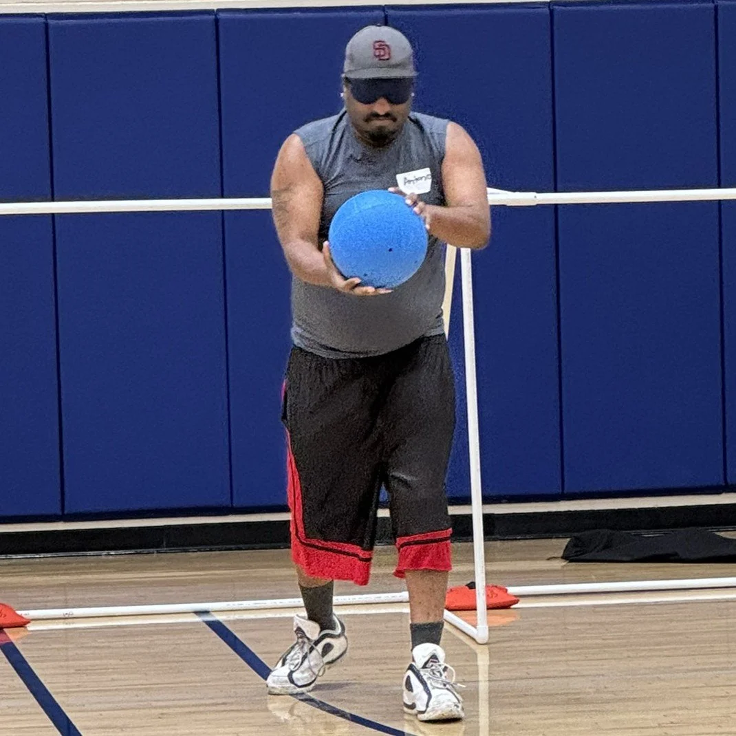Antonio preparing to throw the Goalball during a practice game.