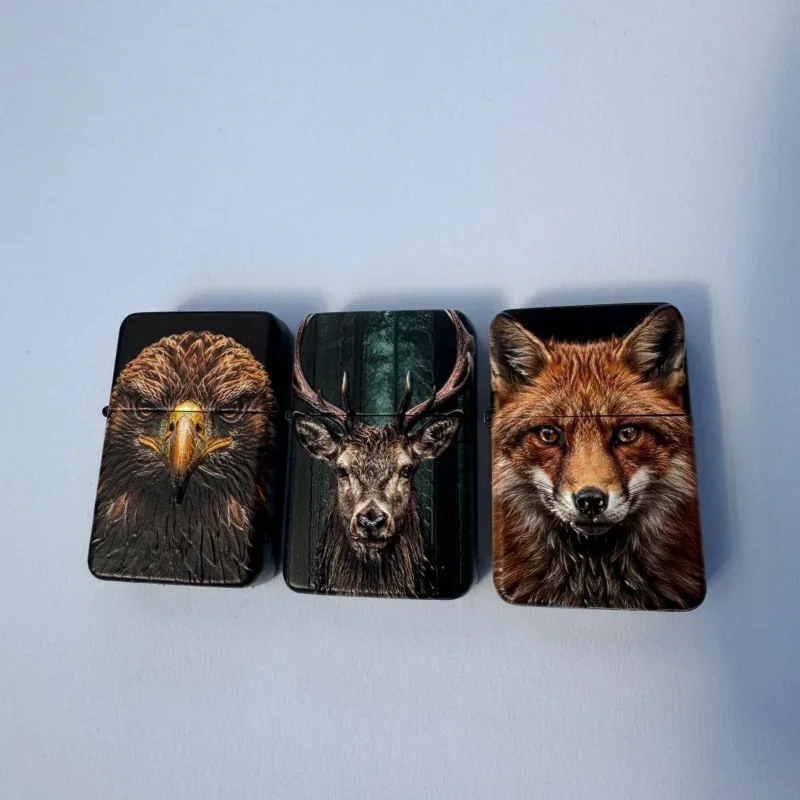 Three black cardholders with animal portraits: an eagle, a deer, and a fox, laid out on a light blue surface.
