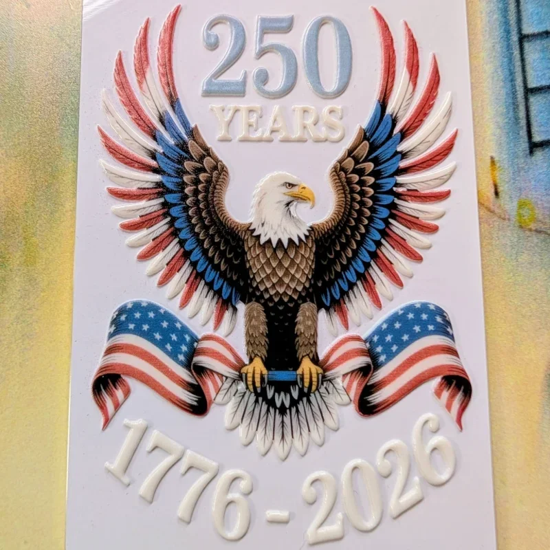 Decorative plaque celebrating the 250th anniversary from 1776 to 2026, featuring an eagle with spread wings holding a ribbon with the American flag pattern.
