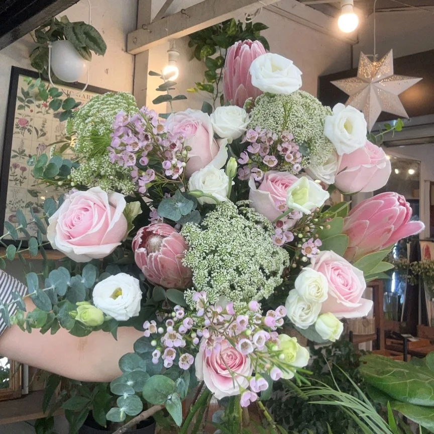 Wild beauty , featuring: roses, protea and airy Queen Anne&rsquo;s Lace