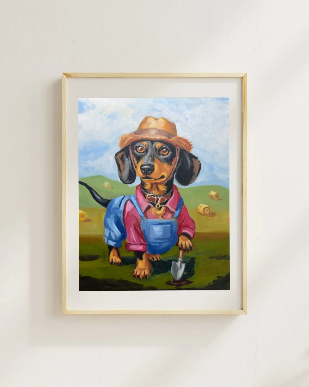 Original oil painting of a black and tan Dachshund dog dressed as a farmer. The dog is wearing a straw hat, a pink shirt, blue overalls, and a collar with a rooster tag.