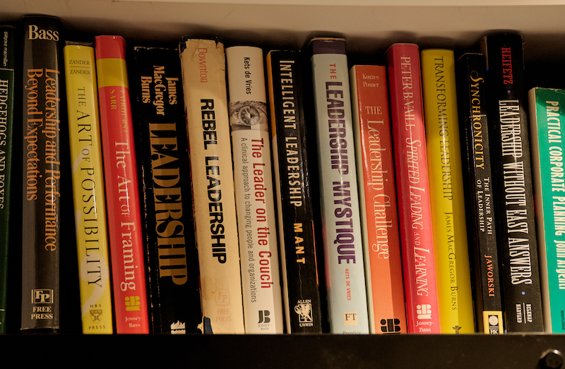 Bookshelves filled with various books on leadership, management, and organizational topics.