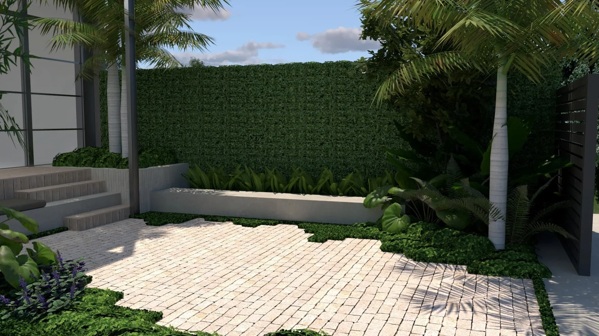 A private outdoor patio area with a paved brick floor, lush green plants, and a tall hedge wall for privacy, surrounded by tropical trees.