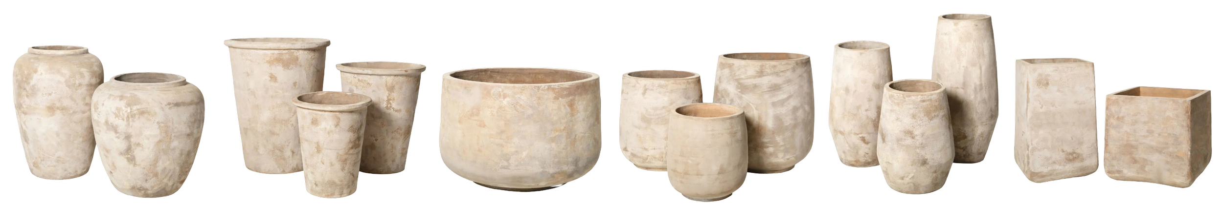 A row of 12 empty, weathered stone or ceramic pots of various sizes and shapes, arranged in a line.