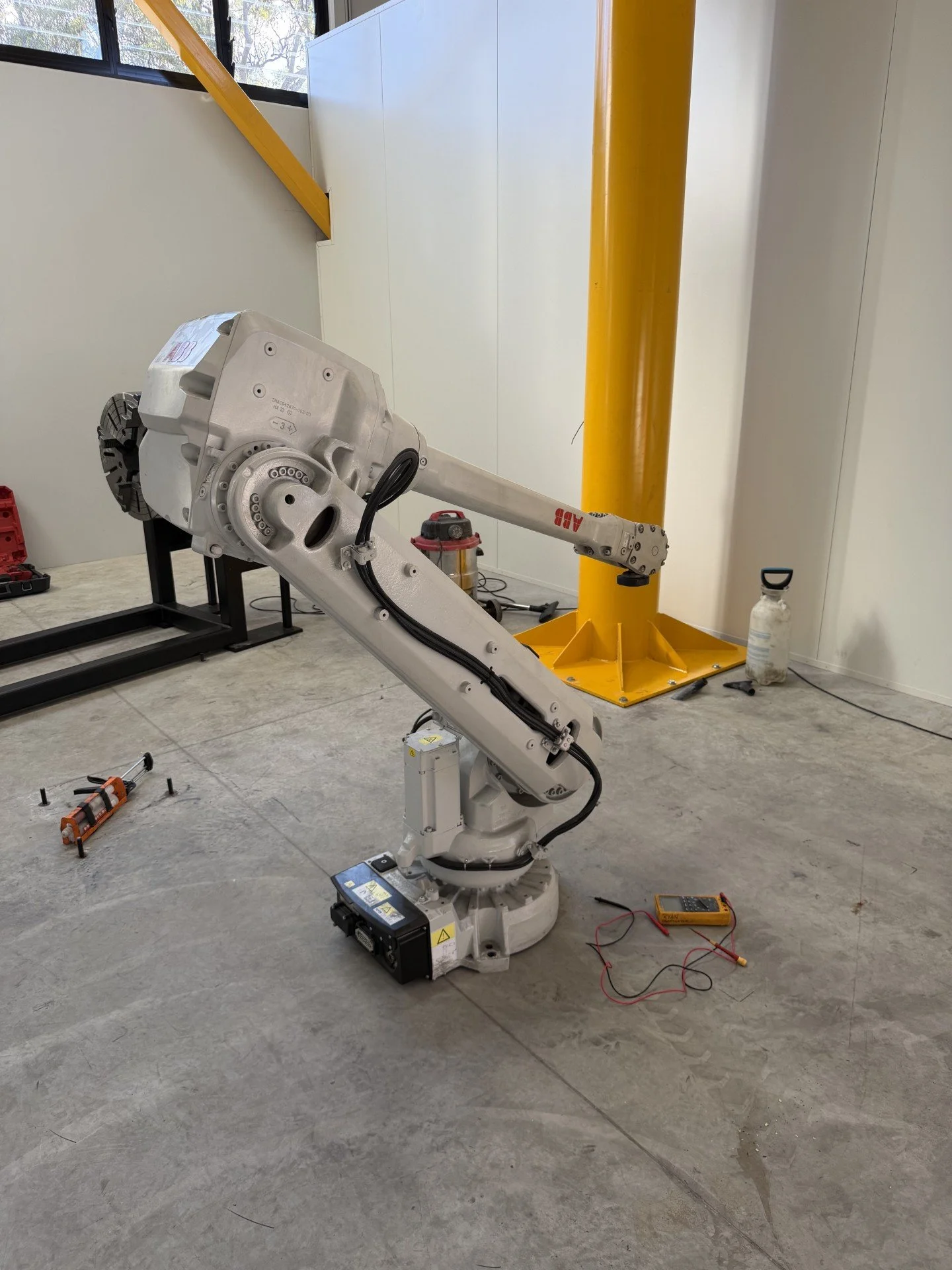 A robotic arm for an automated production line being installed in a factory.