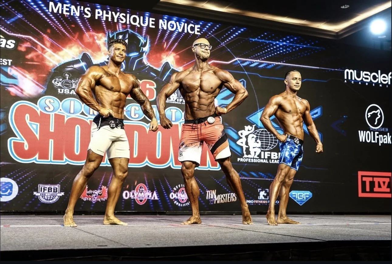 Stuart Paul bodybuilding competition pose with competetor