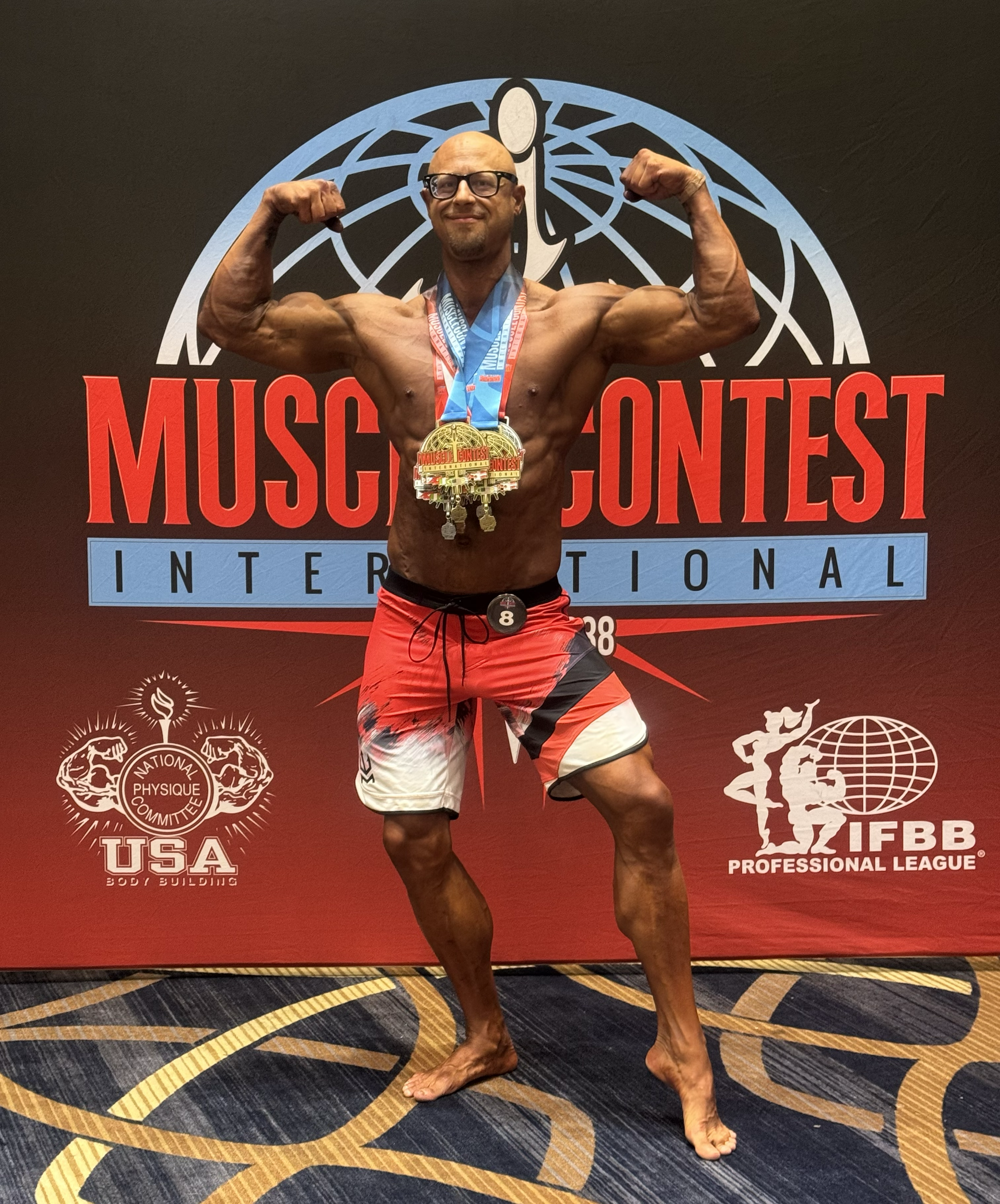 Stuart Paul bodybuilding competition award pose