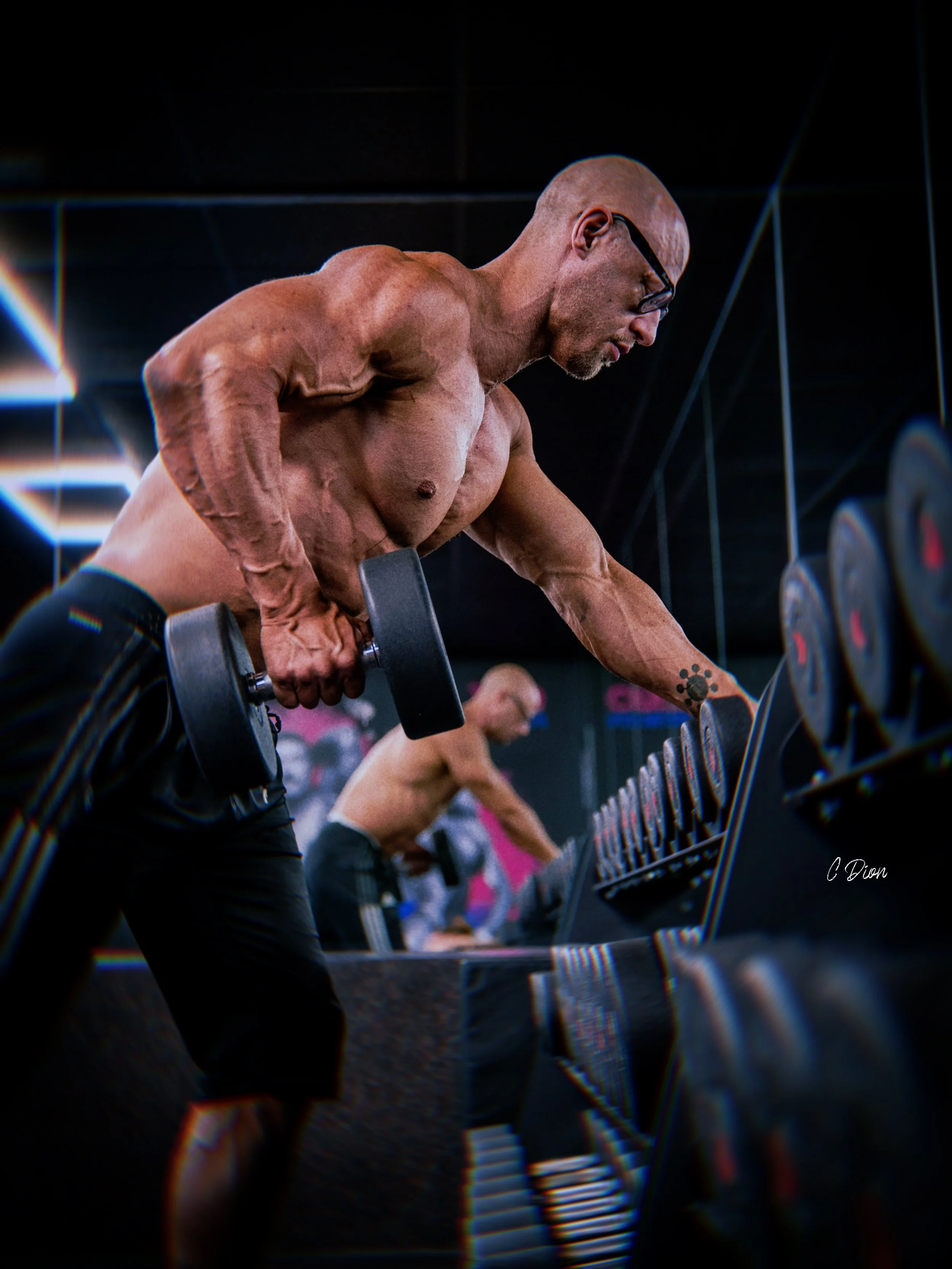 Personal trainer selecting dumbbells at Above the Line Fitness gym