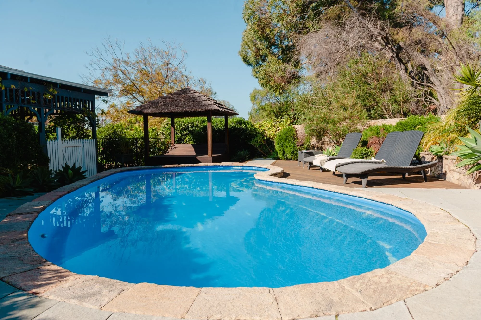 Swimming pool surrounded by gardens at Lanterns Retreat in Old Dunsborough