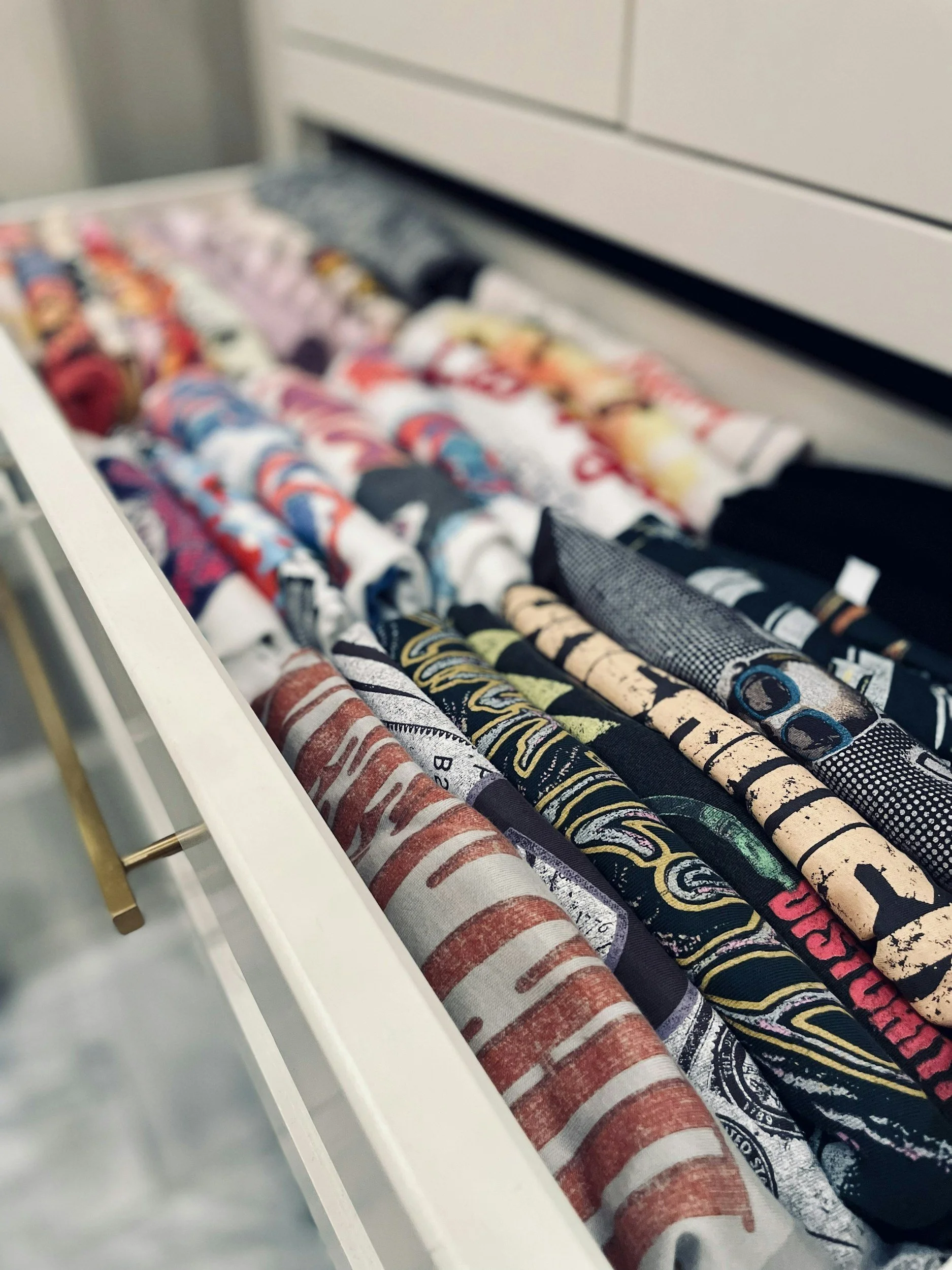 T-shirts folded upright in a drawer using the KonMari method
