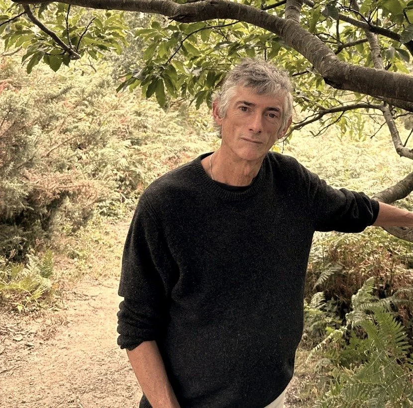 Simon Goodrich, bioresonance therapist based in Fairlight, Sussex, standing outdoors on a woodland path