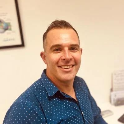 Brad Raison standing in an office.