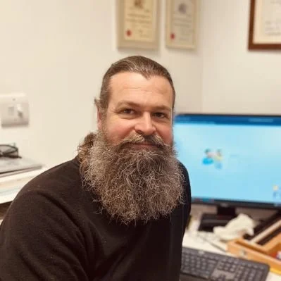 James Kerr sitting at desk with computer