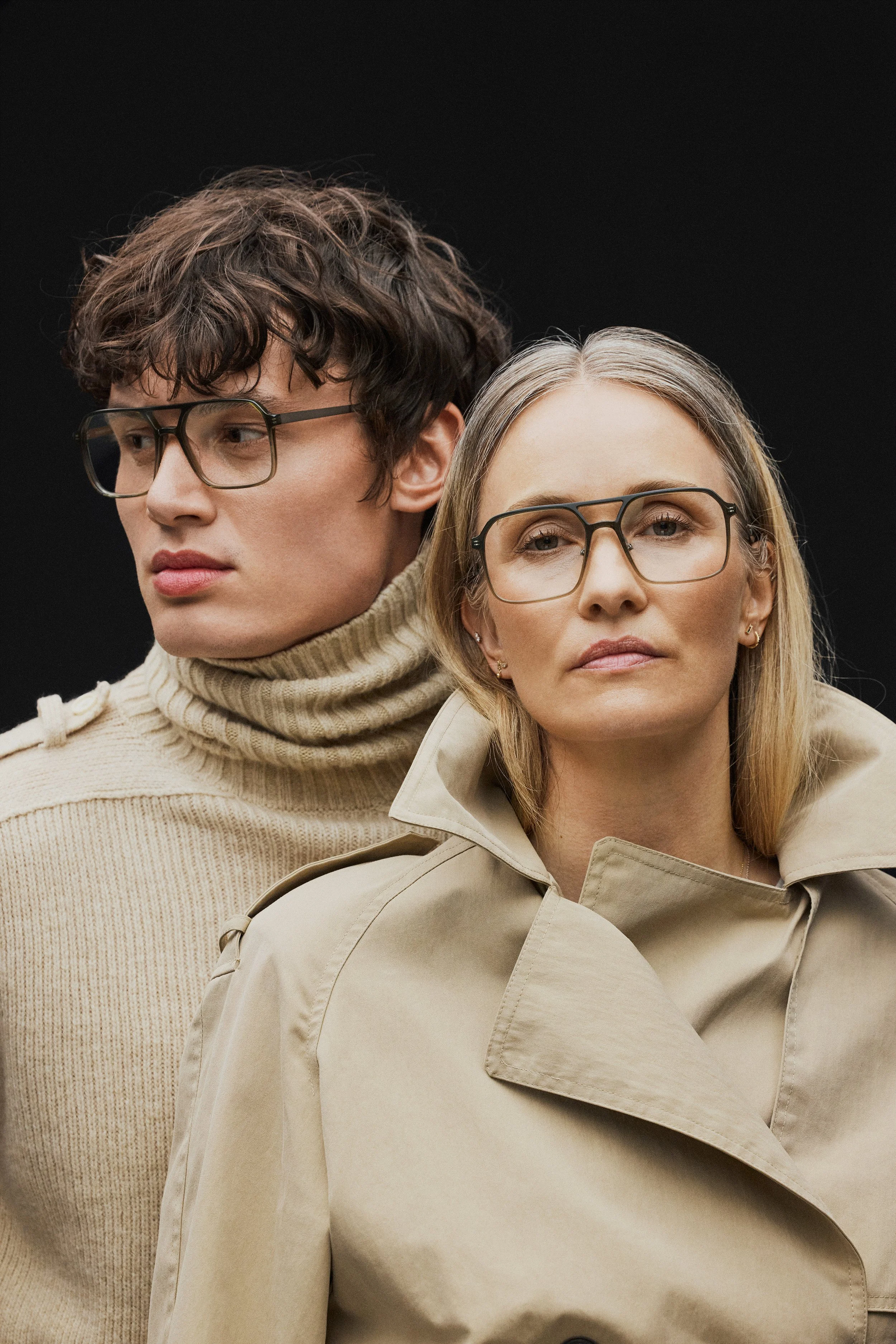 Close-up of a young man and woman wearing glasses.