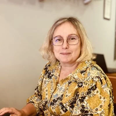 Dawn Parkes sitting in the optometry office.