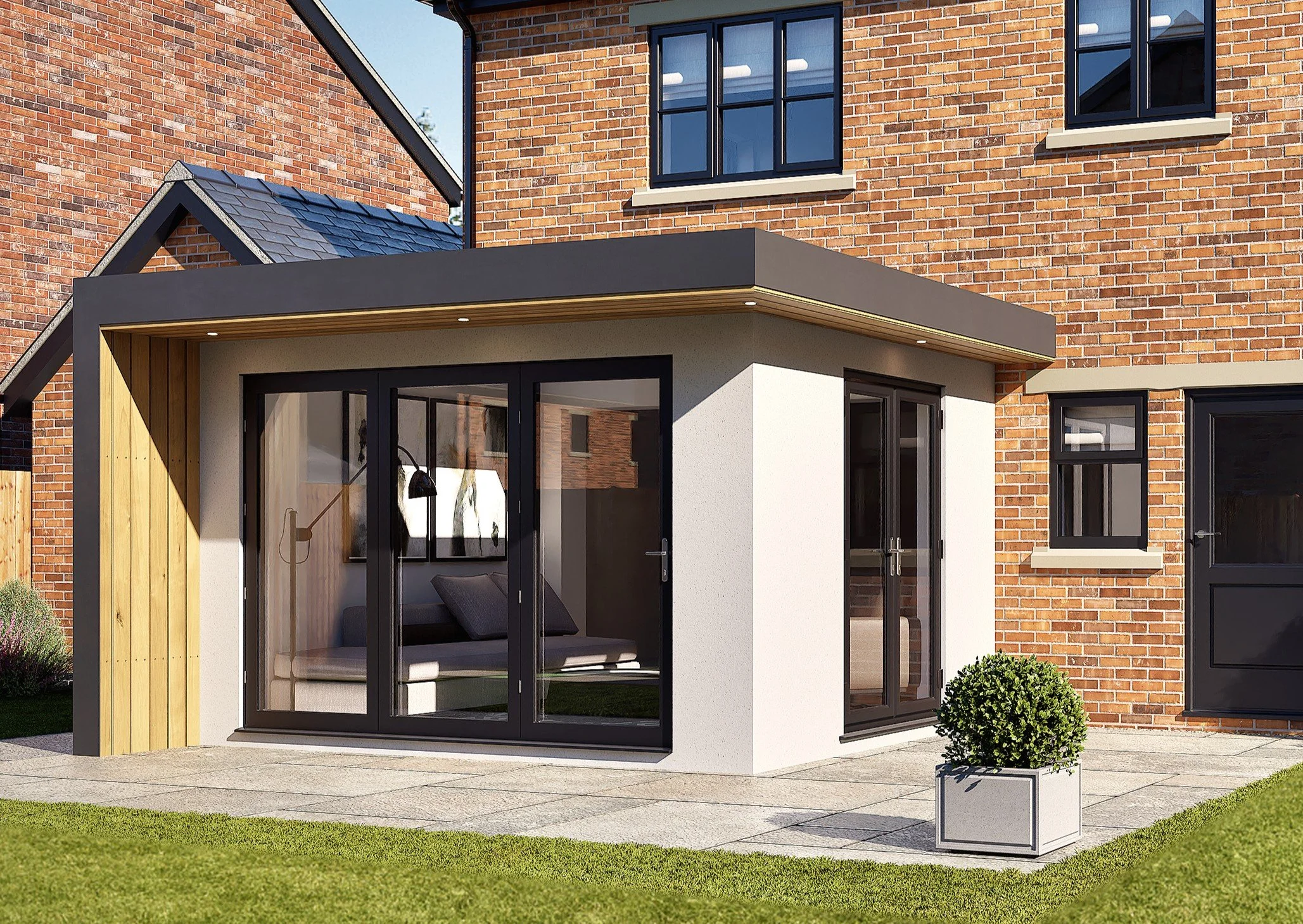 Modern back porch with large sliding glass doors, a small window, and outdoor seating area. The house features a brick exterior with black window frames and a gray roof. There is a small bush in a decorative planter and a concrete patio with a grassy lawn.