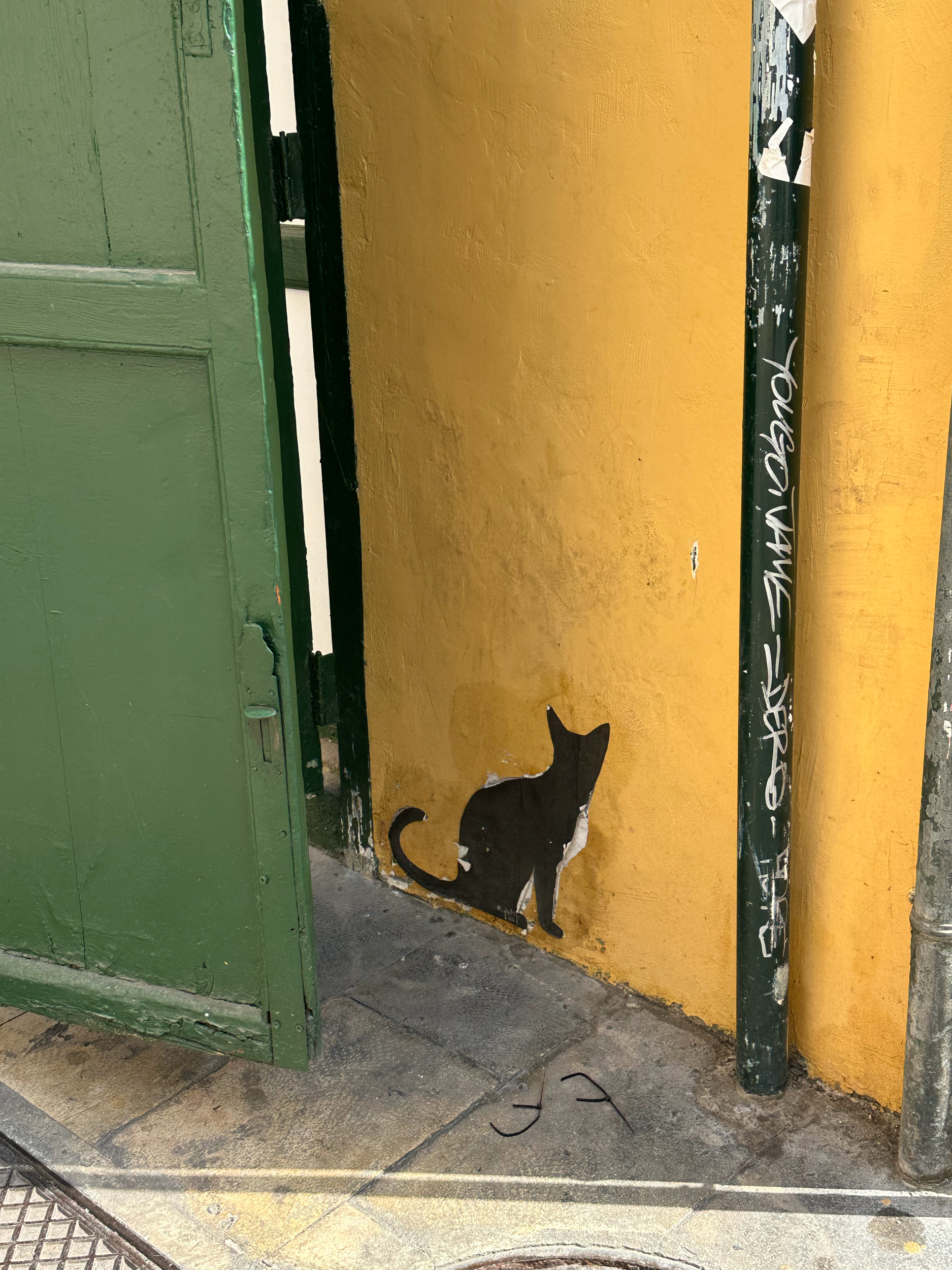 Julia LooL's paper paste black cats can be found hiding around the city. 