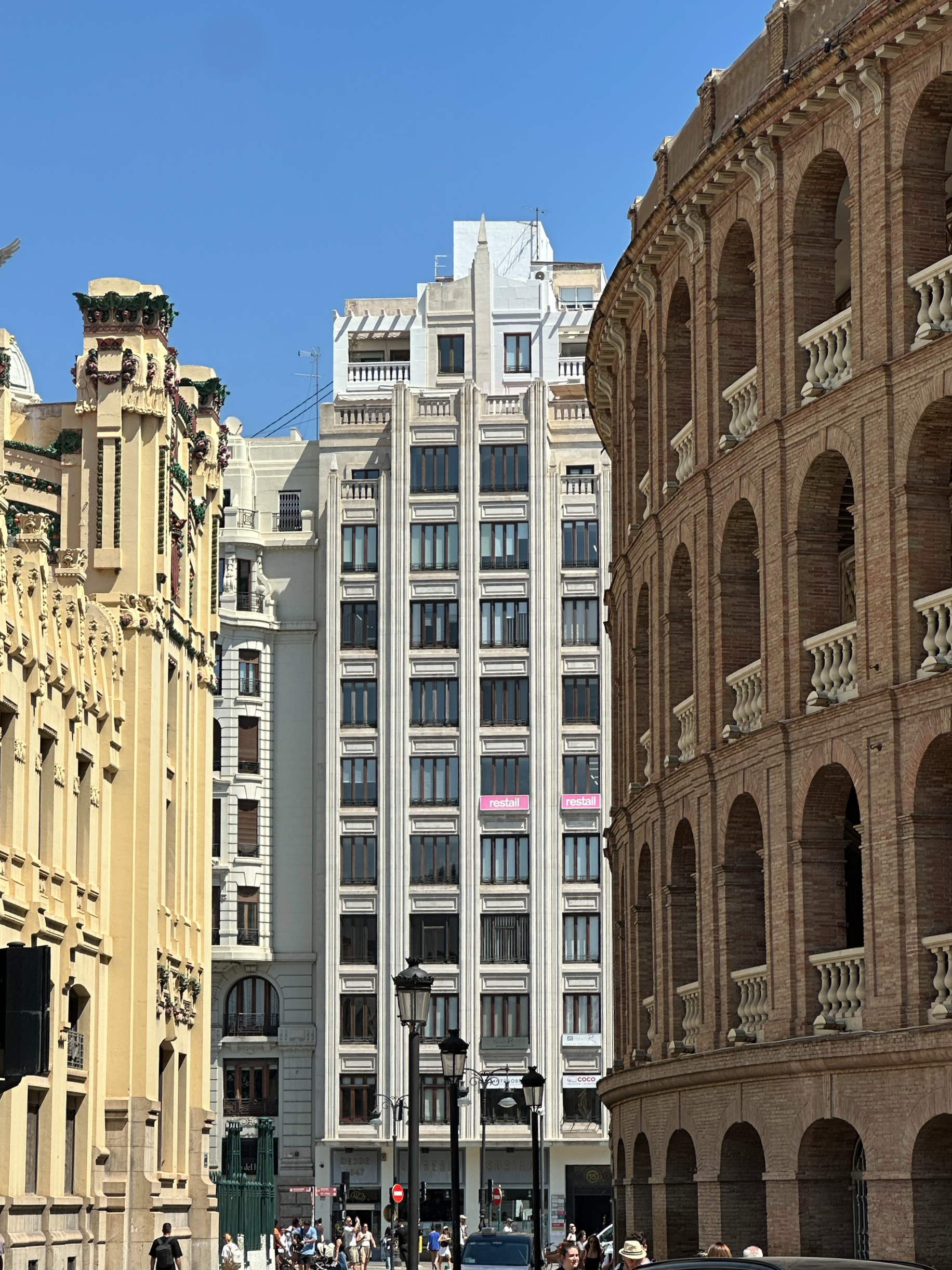 The train station on the left and the bullfighting ring on the right.