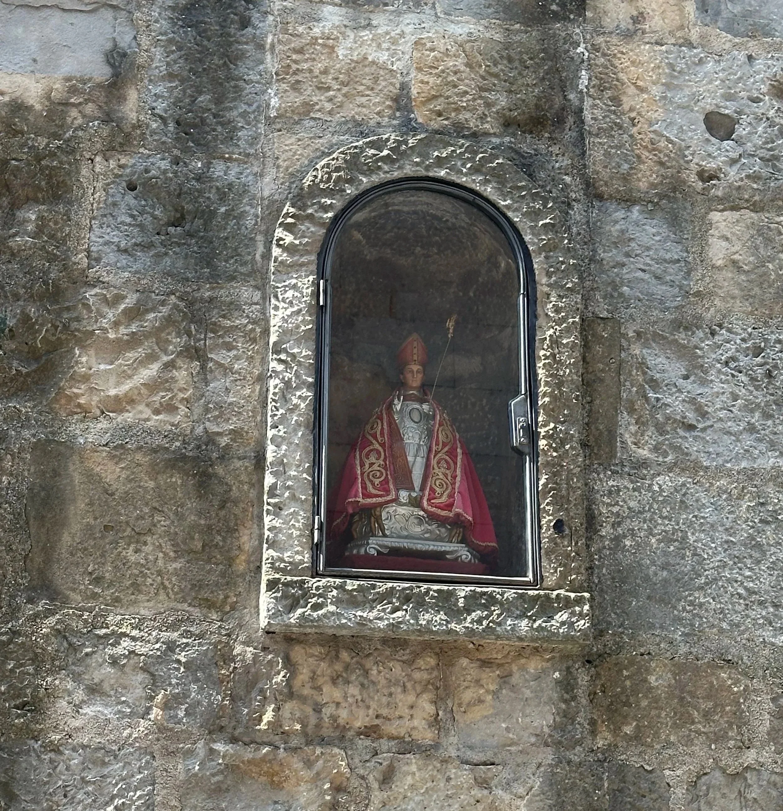 A small statue of San Fermin sits in this portion of the wall.  Before the start of the race, the runners sing to San Fermin three times to ask for his protection and blessing.  
