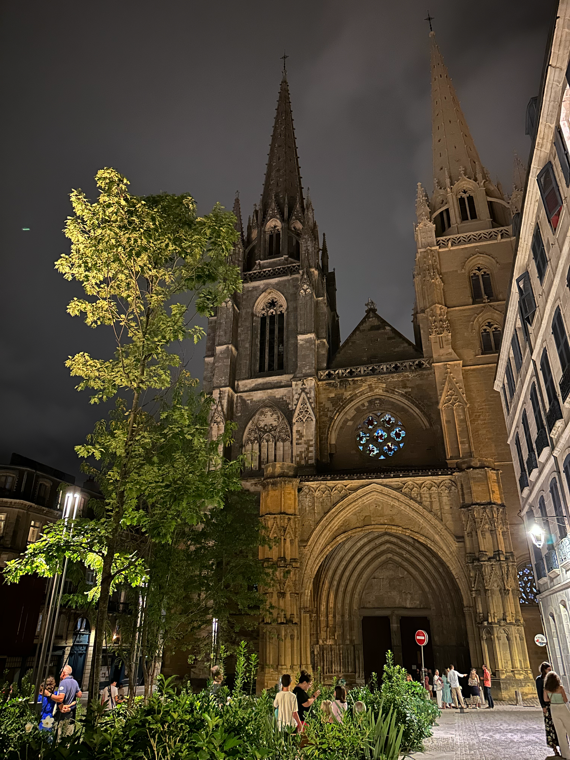 The front of the cathedral in the dark of night.   Notice that one tower is light while the other remains a darker color.  Restoration of the cathedral is being completed in sections, and one spiral has not yet been restored.   