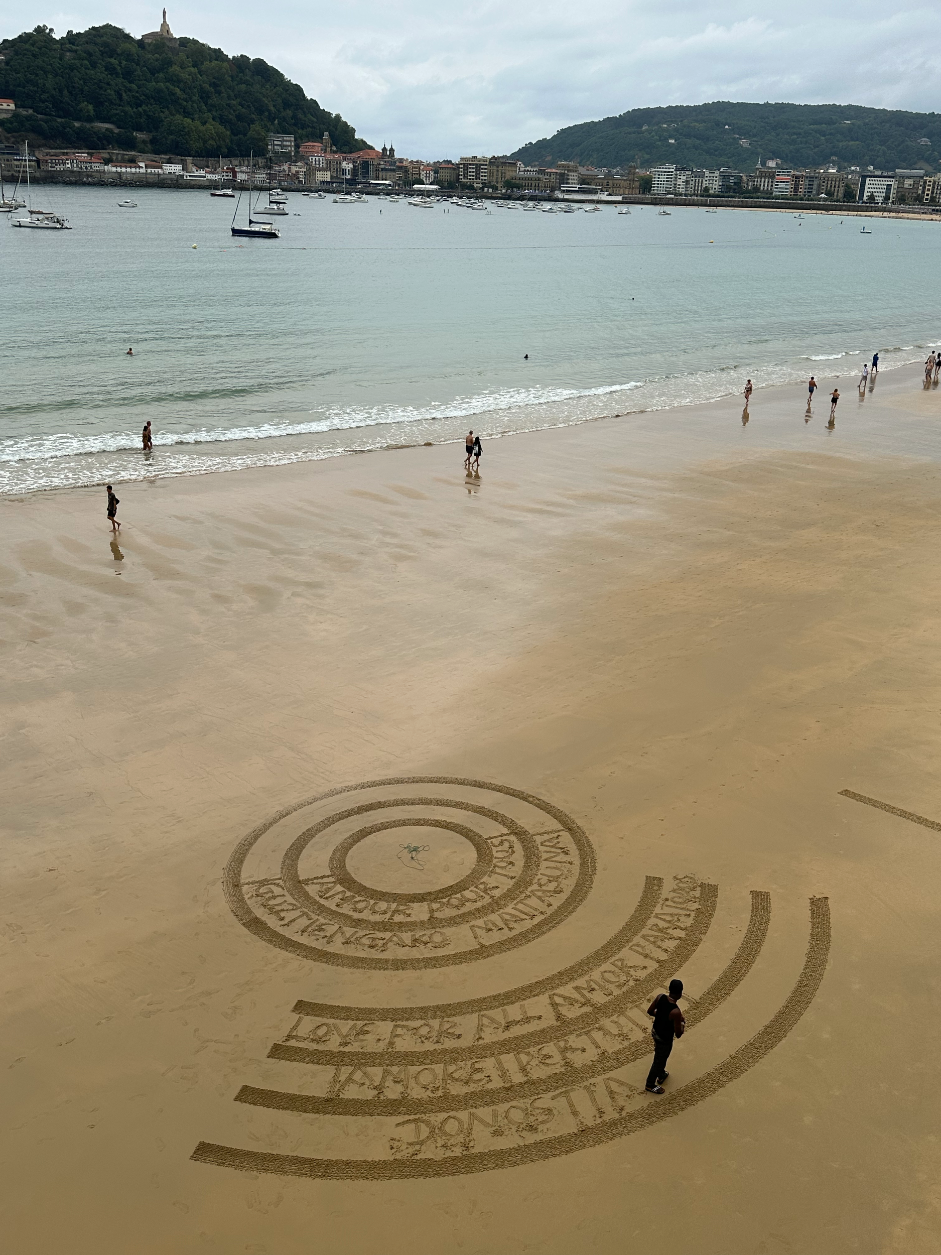 Artists claim sections of this large sandy beach to draw and create designs and patterns.  They all have Instagram tags as well and a bucket down in the sand where you can throw tips down to them.  