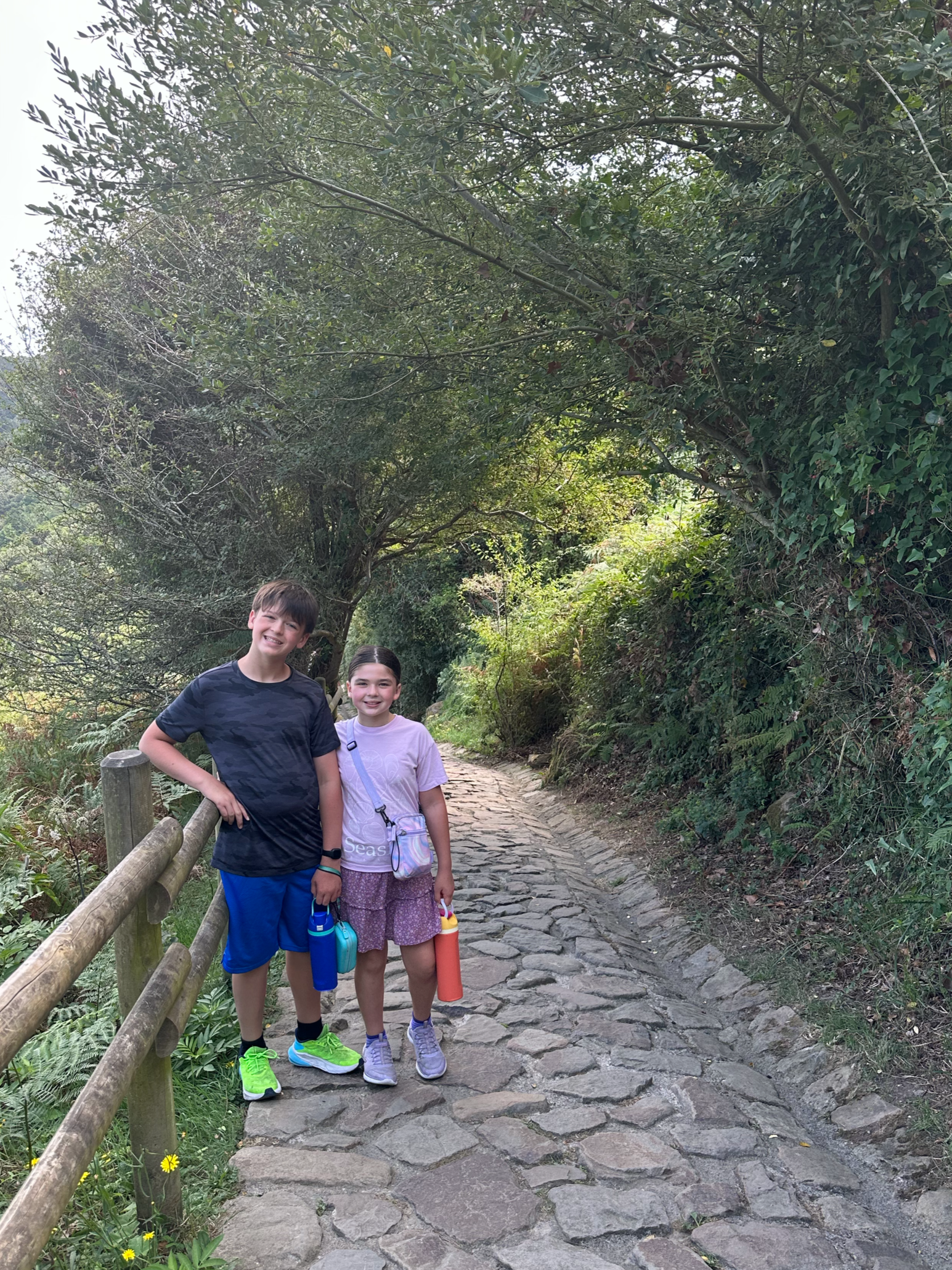Set with water bottles and ready to head down the path that began with large stones