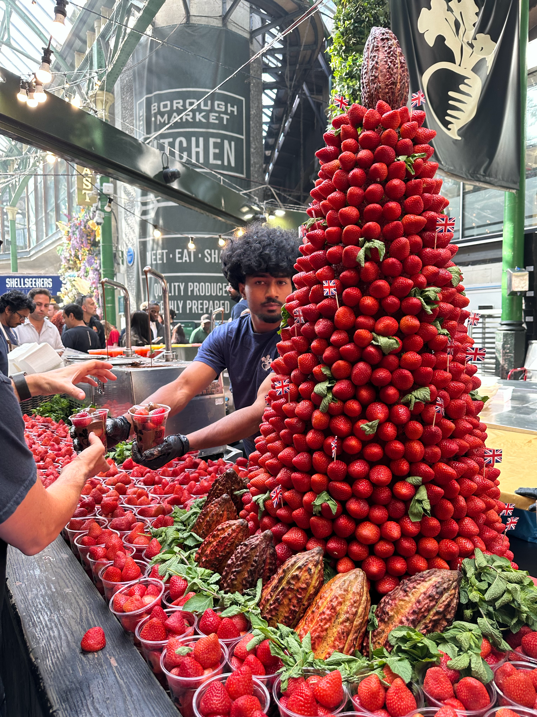 So many strawberries! If you look behind the man handing out the cups of strawberries and chocolate, you can see the spigots with liquid chocolate flowing out.