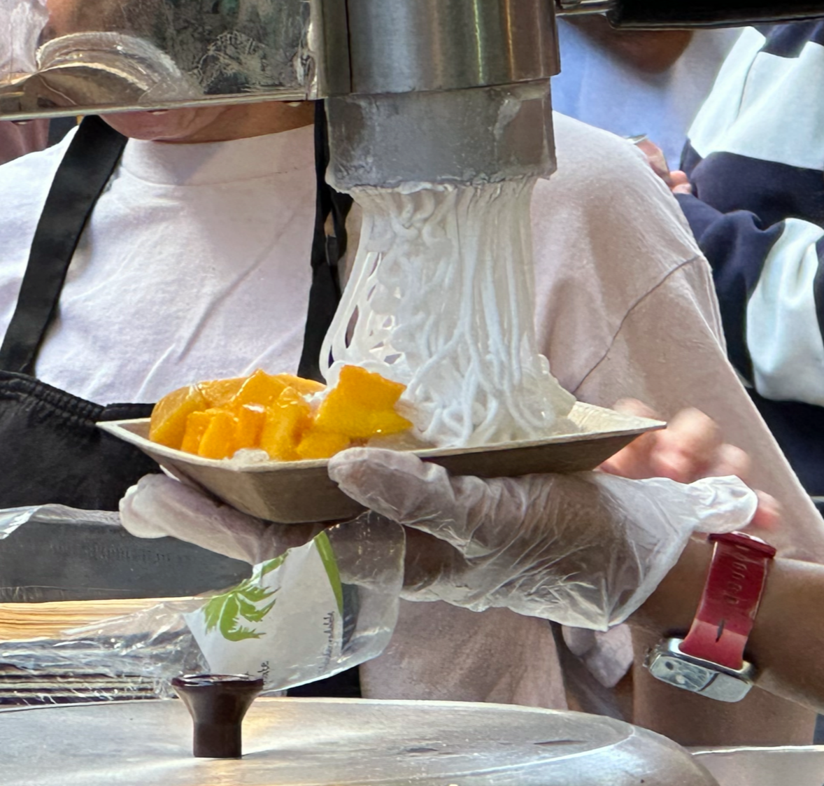When we walked around the corner from The Black Pig we saw Khanom Krok Thai and this dessert being prepared.  We all love mango with sticky rice and when we saw them preparing it with "coconut ice-cream noodles," we were in!