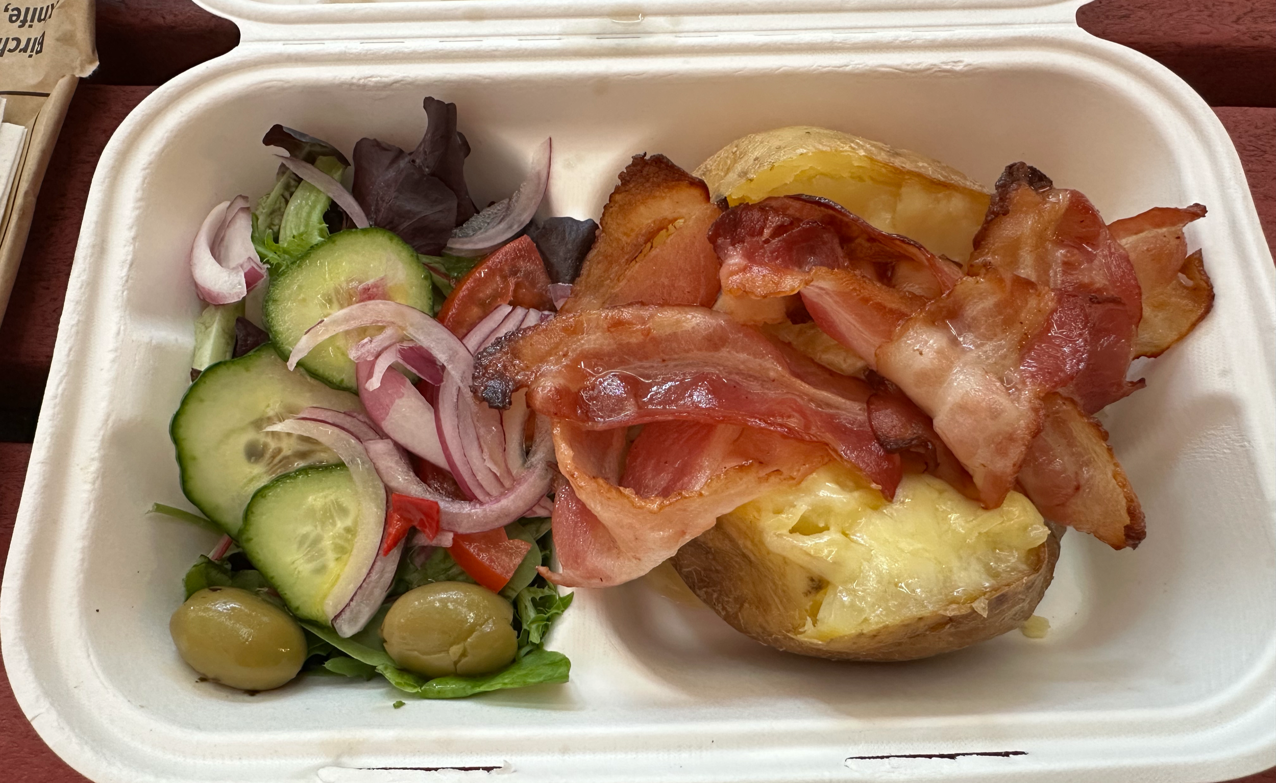 The baked potatoes were really delicious.  This one has butter, bacon, and cheese, and a side salad. 