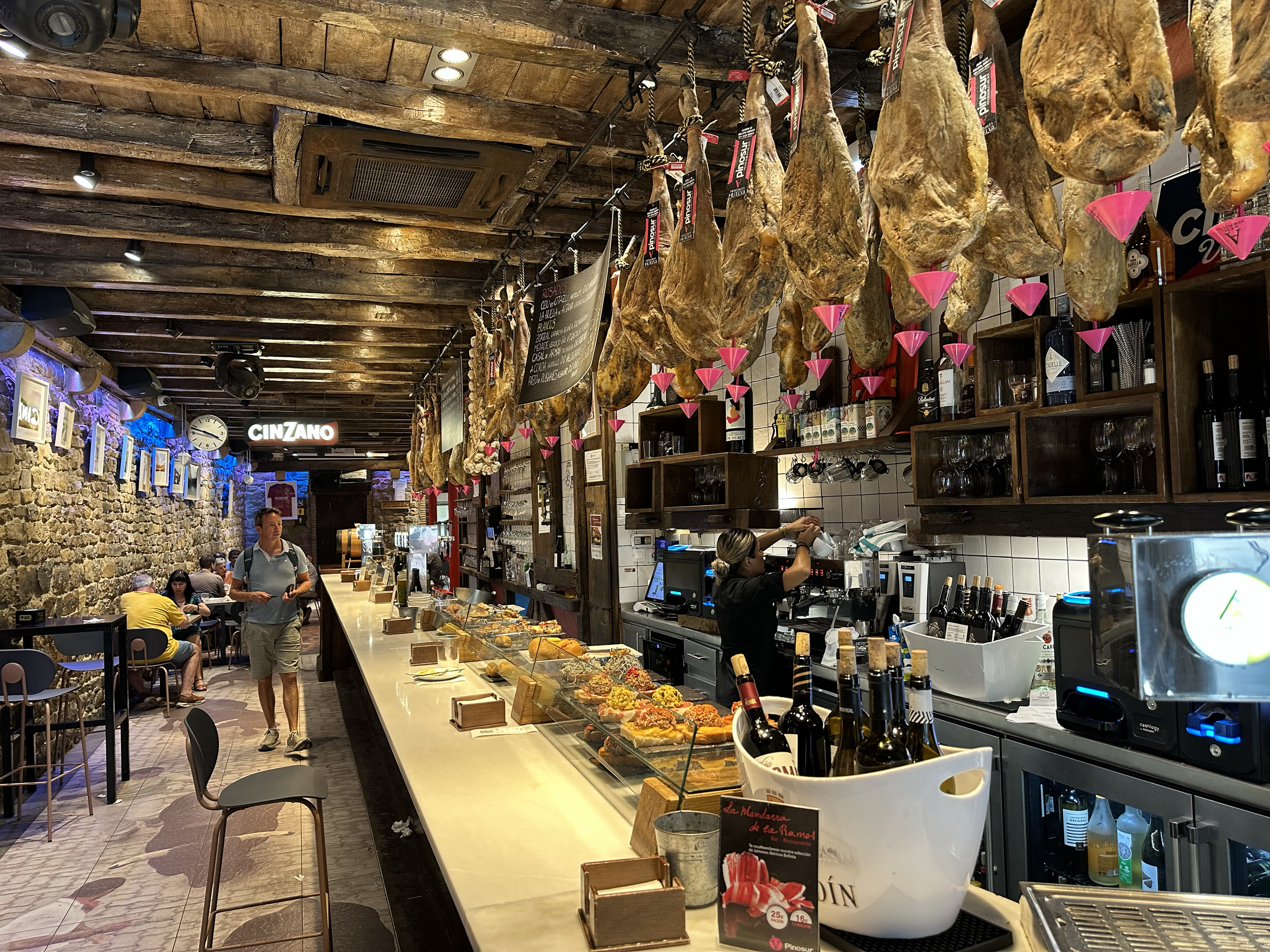 A beautiful display of pintxos, braided garlic, and ham (Iberico and/or serrano).  