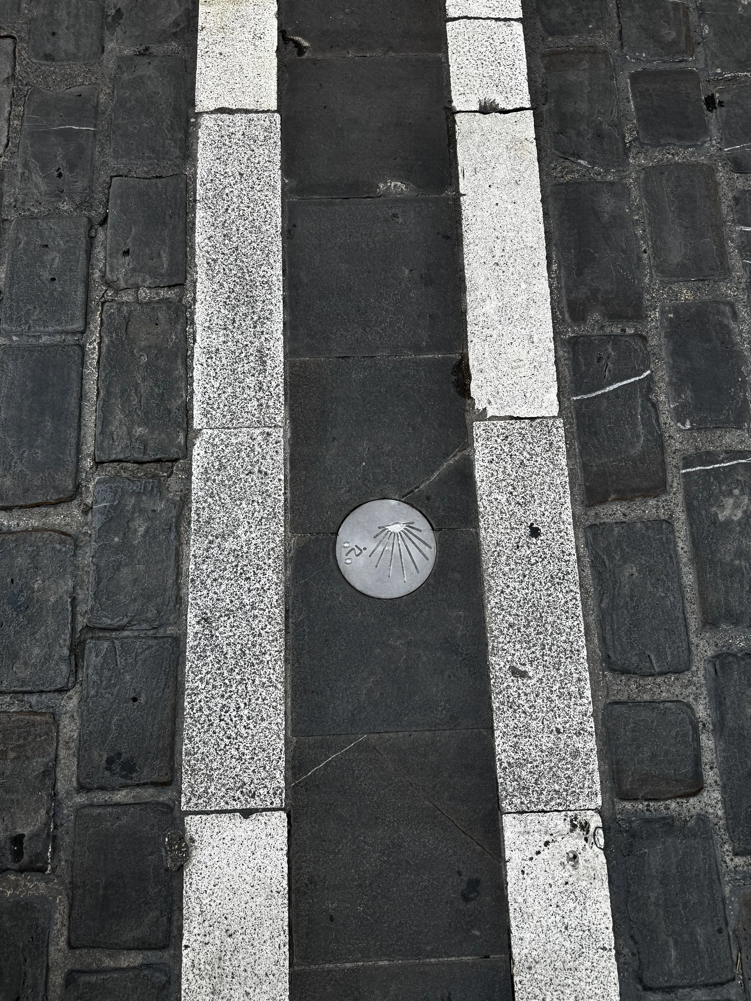 Route marker for El Camino de Santiago.  One of the legendary pilgrimage routes to Compostela runs right through Pamplona.