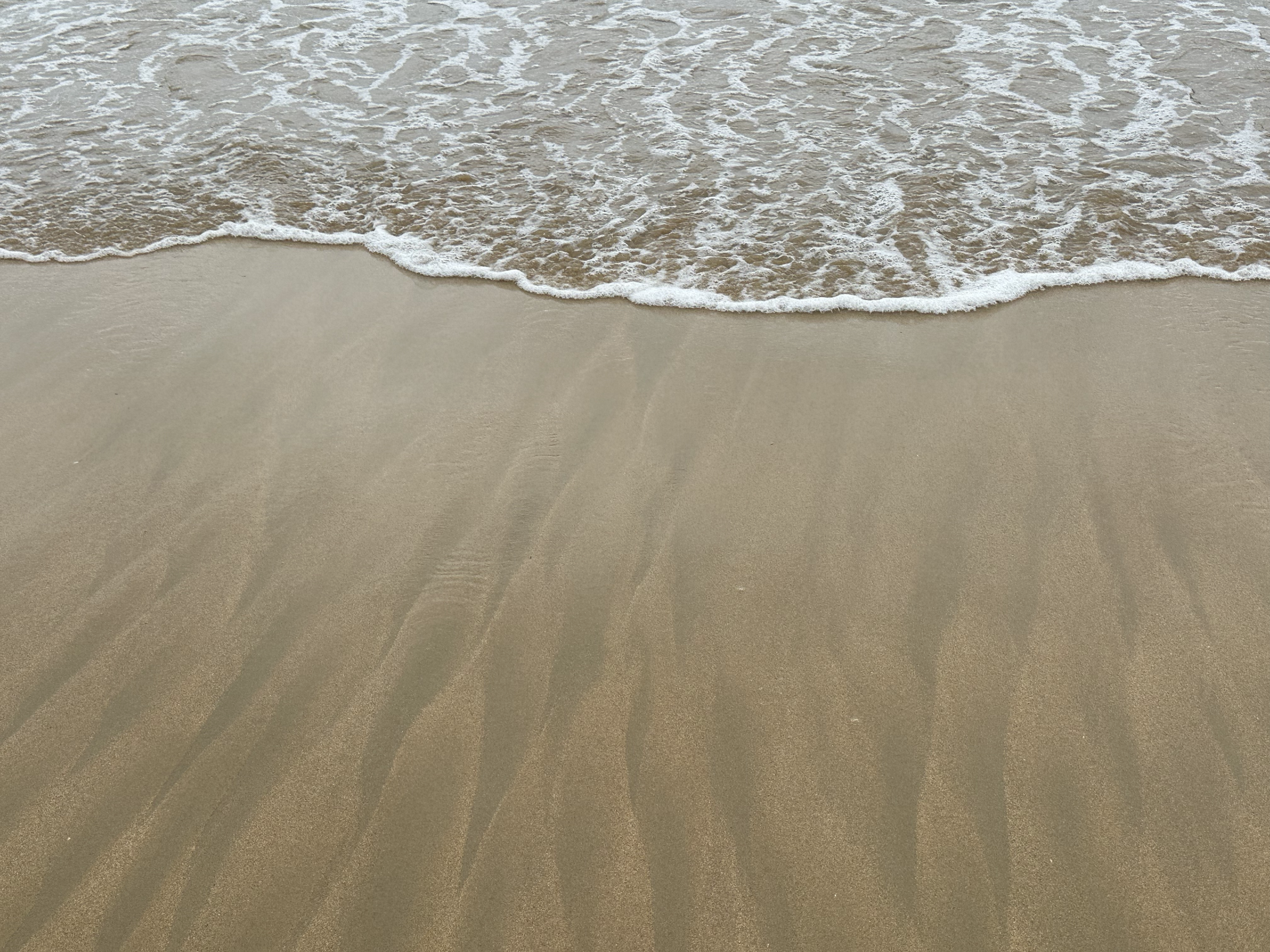 The flow of the water made beautiful patterns in the sand.  
