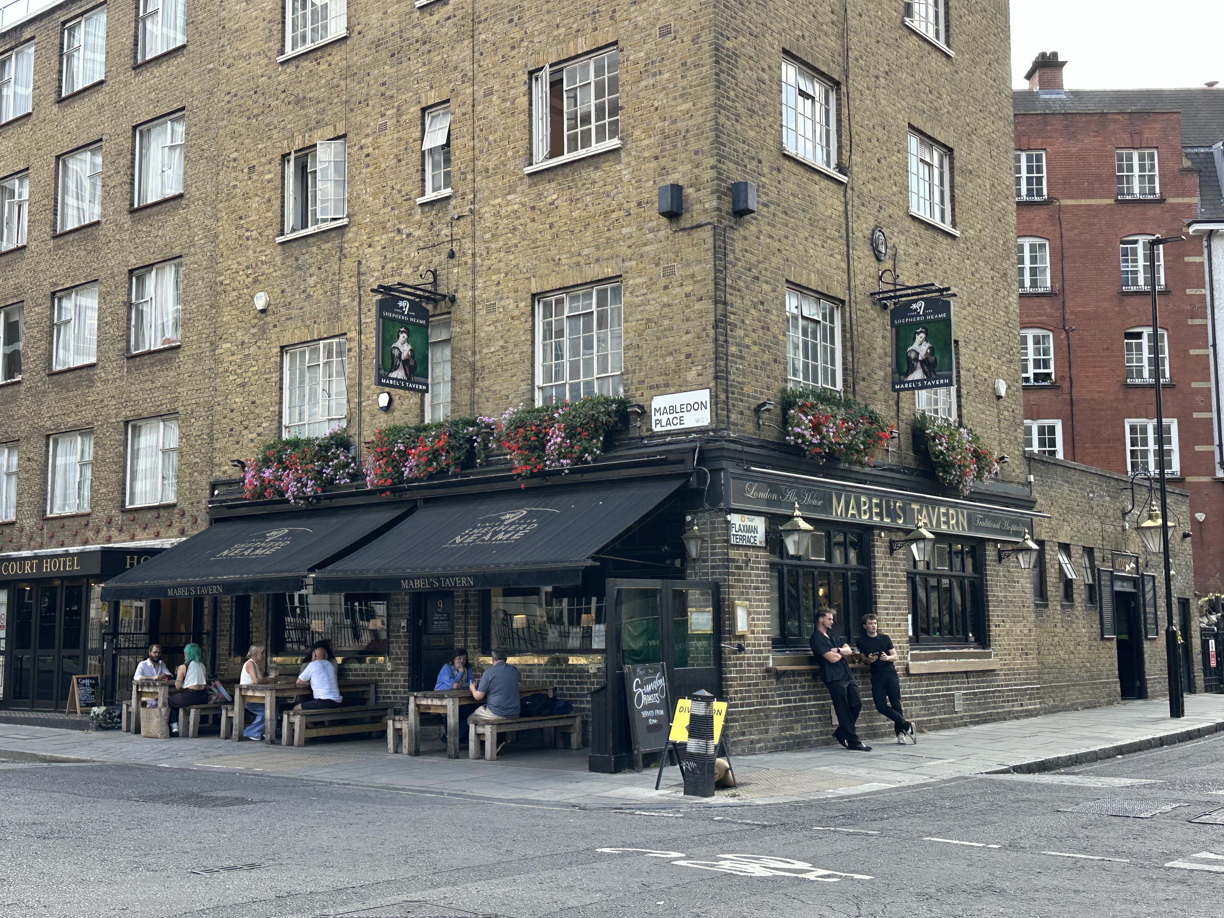 More beautiful flowers above pub windows as we walk along in town.  