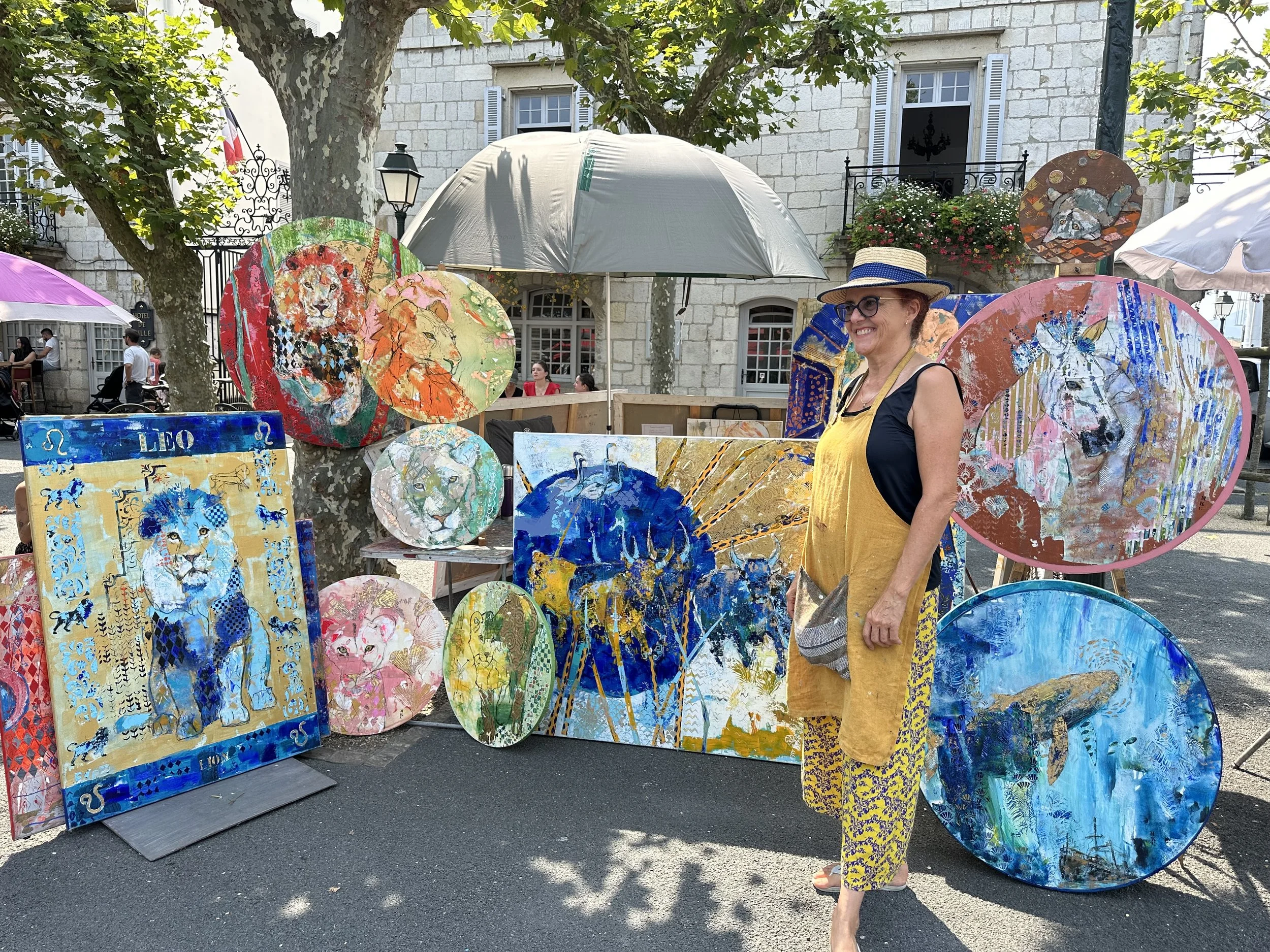 After talking to the artist, she even let me take a picture of her with her work. Joshua especially loved the blue lion painting.