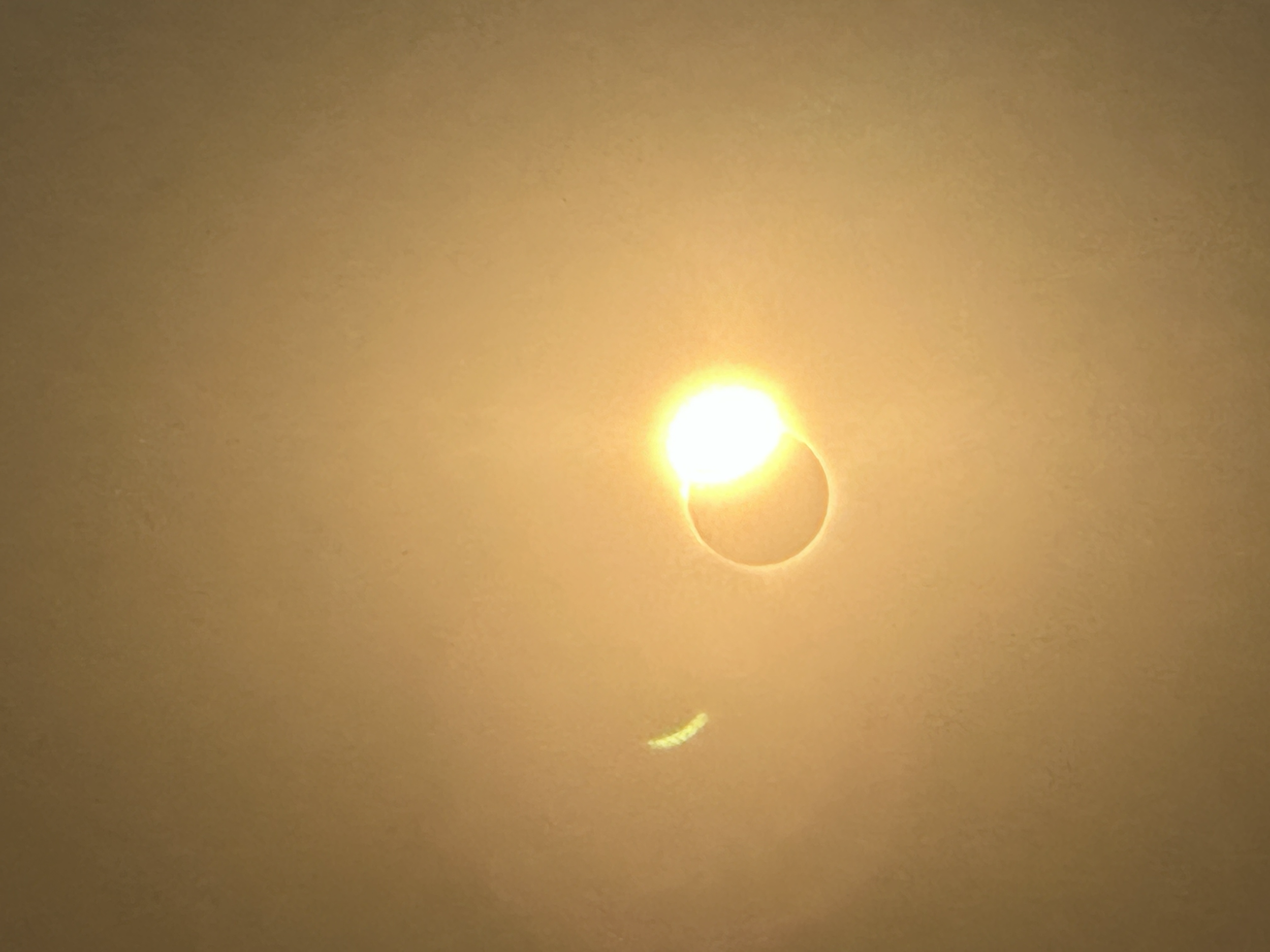Rachel was able to capture the eclipse by placing her protective glasses over the camera lens on her phone. (Not award winning, but still special to have for the memory and to share). The moon has mostly covered the sun at this point, but a sliver of