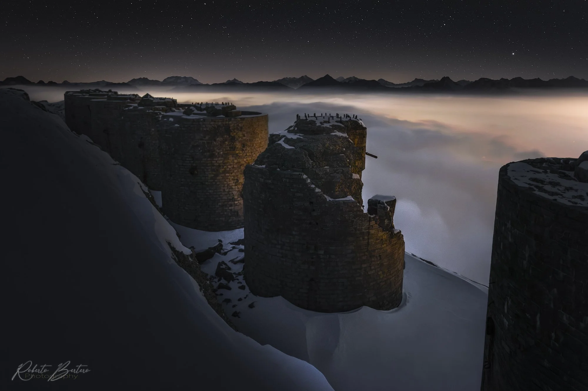 Mount Chaberton military fortress by night, with a caret of clouds below