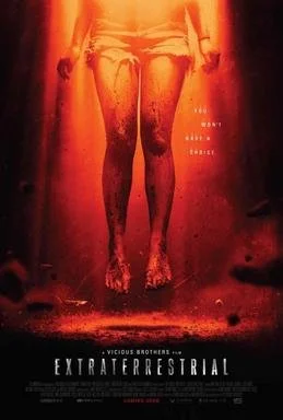 A person standing with their head out of view, in a fiery red and orange environment with the film title "Extraterrestrial" and the tagline "We want to believe" visible at the bottom.