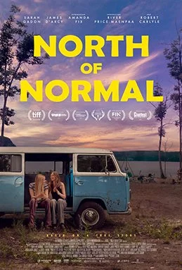 Movie poster for 'North of Normal' with a sunset over a lake, trees, and a vintage van with two women sitting on the step.