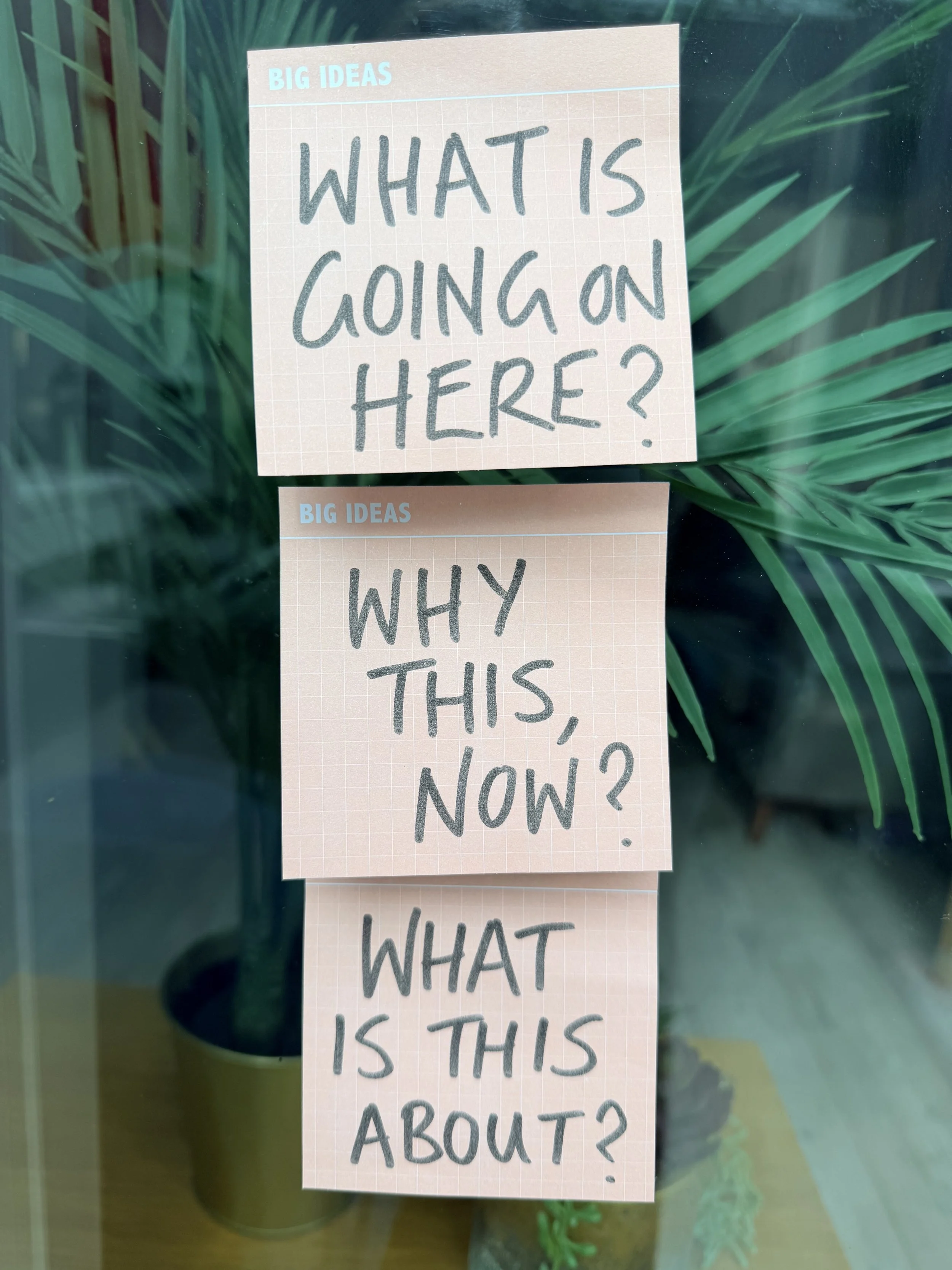 Three sticky notes saying What is going on here? Why this, now? and What is this about?